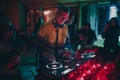 Chisinau, Moldova 11.10.2019. Rave techno DJ plays concert set with CD player turn table & Pioneer sound mixer surrounded by Royalty Free Stock Photo