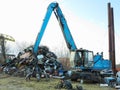 17.03.2023 Chisinau, Moldova: Scrap metal machine crane moving recycled steel
