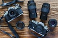 Chisinau, Republic of Moldova - Jule 06, 2017: Two vintage film cameras Minolta XD 7 and Minolta X-300 and lenses on wooden backgr