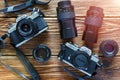 Chisinau, Republic of Moldova - Jule 06, 2017: Two vintage film cameras Minolta XD 7 and Minolta X-300 and lenses on wooden backgr