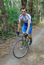 Chisinau, Republic of Moldova - July 16, 2017: cyclist at team Katusha rides a bicycle along a forest road. Looking at the camera.