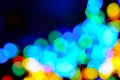 Chistmas background with a coloutful bokeh against deep blue. Defocused