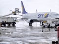 Airplane cleaner service washing mud and snow from SKY airline`s aircraft