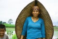 Chitwan Nepal ,04 April 2020:Nepali woman posing for a camera during paddy plantation from Chitwan Nepal.