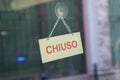 Chiuso transl. closed sign in shop window Royalty Free Stock Photo