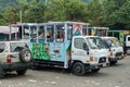 Chiva party buses parked at a park