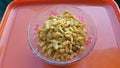 Chiwda snack in bowl on orange background Royalty Free Stock Photo