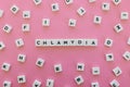 Chlamydia word made of square letter word on pink background. Royalty Free Stock Photo