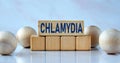 CHLAMYDIA - word on wooden cubes on a light background with balls