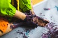 Little kid hands and feet covered with multiple colours