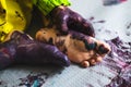 Little kid hands and feet covered with multiple colours