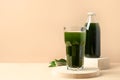 Chlorella Detox drink in glass on beige. Close up.