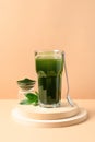 Chlorella healthy beverage in glass on a grey background