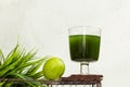 Chlorella detox healthy drink in glass with lime on the podium on a light background. Superfood, natural antioxidant for a green