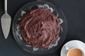 Choclolate cake on glass plate with silver server and cup of tea Royalty Free Stock Photo