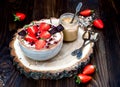 Chocolate almond butter maca smoothie bowl topped with sliced strawberries, chopped chocolate and pomegranate seeds