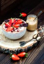 Chocolate almond butter maca smoothie bowl topped with sliced strawberries, chopped chocolate and pomegranate seeds Royalty Free Stock Photo