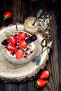 Chocolate almond butter maca smoothie bowl topped with sliced strawberries, chopped chocolate and pomegranate seeds Royalty Free Stock Photo