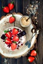 Chocolate almond butter maca smoothie bowl topped with sliced strawberries, chopped chocolate and pomegranate seeds Royalty Free Stock Photo