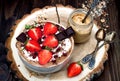 Chocolate almond butter maca smoothie bowl topped with sliced strawberries, chopped chocolate and pomegranate seeds Royalty Free Stock Photo