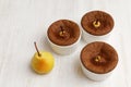 Chocolate-almond dessert with pears in white ceramic baking dish