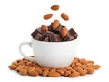 Chocolate and almonds in a cup isolated on white background Royalty Free Stock Photo