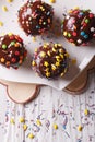Chocolate apples with sprinkles candy close up vertical top view
