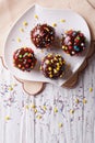 Chocolate apples with sprinkles candy. vertical top view