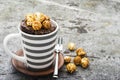 Chocolate aromatic mug cake with caramel appetizing popcorn for autumn cozy warm tea drinking on a gray stone background Royalty Free Stock Photo