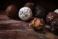 Chocolate, assortment of round truffle pralines on dark rustic w Royalty Free Stock Photo