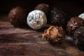 Chocolate, assortment of round truffle pralines on dark rustic w