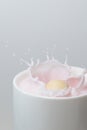 Chocolate ball falling into a cup of strawberry milkshake Royalty Free Stock Photo