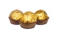 Chocolate balls wraped with golden foil isolated on white Royalty Free Stock Photo