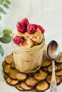 Chocolate banana ice cream, raspberries in a glass jar. Selective focus.