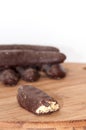 Chocolate bananas on a kitchen wooden board