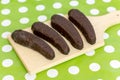 Chocolate bananas on the wooden board