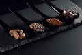 Chocolate bar, cocoa powder, cacao beans and nibs, heap in wooden spoons, chocolate background Royalty Free Stock Photo