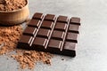 Chocolate bar and cocoa powder on grey Royalty Free Stock Photo