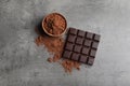 Chocolate bar and cocoa powder on grey background Royalty Free Stock Photo