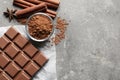 Chocolate bar and cocoa powder on grey background Royalty Free Stock Photo