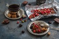 Chocolate bar with dry berries on silver vintage plate, close view, dark background Royalty Free Stock Photo