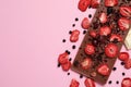 Chocolate bar with freeze dried fruits on pink background, flat lay. Space for text Royalty Free Stock Photo