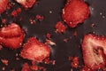 Chocolate bar with freeze dried strawberries as background, closeup Royalty Free Stock Photo