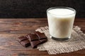 Chocolate bar and glass of milk on wooden. Royalty Free Stock Photo