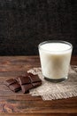 Chocolate bar and glass of milk on wooden. Royalty Free Stock Photo