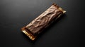 Chocolate bar in gold foil wrapper on dark background Royalty Free Stock Photo