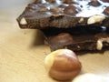 Chocolate bar with hazelnuts. Sliced chocolate with nuts. Beautiful sweets.
