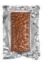 Chocolate bar with nuts in aluminum foil Royalty Free Stock Photo