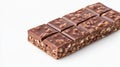 Milk chocolate bar featuring crispy puffed rice, segmented into bite sized squares, resting on pristine white surface Royalty Free Stock Photo