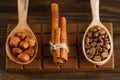 Chocolate bar, shelled hazelnuts, roasted coffee beans, cinnamon on wooden background